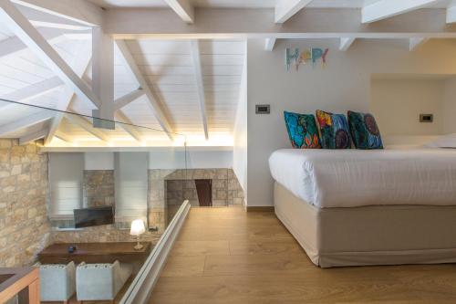 a bedroom with a bed and a fireplace at Anthemion Suites and Villas in Nafplio