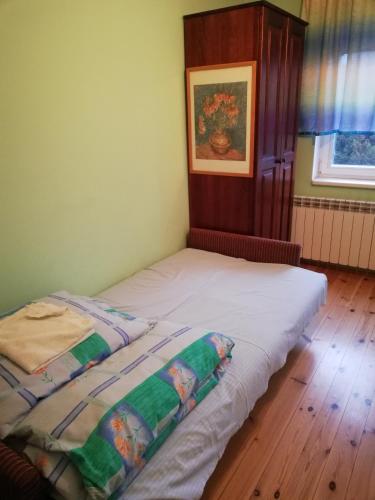 a bed with two pillows on it in a room at Pokoje Gościnne Lalaj in Bolęcin