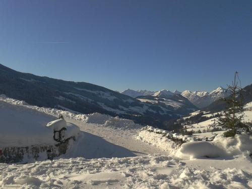 a snow covered mountain with mountains in the background at Bergwald Appartements Alpbach in Alpbach