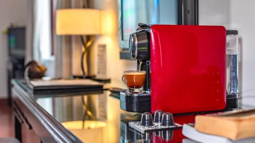 a coffee maker sitting on a counter with a glass at White Mansion 白色公馆 in Phnom Penh