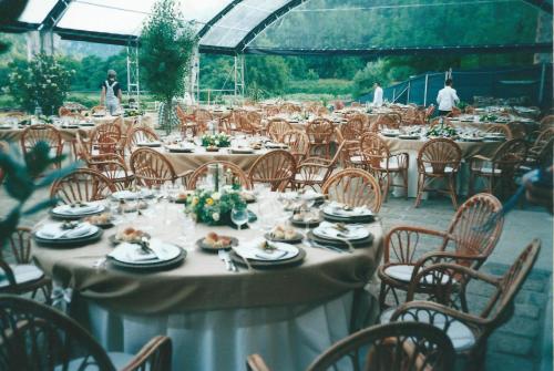 a group of tables and chairs with food on them at Agriturismo Le Forre del Treja in Civita Castellana