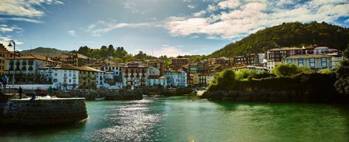 a view of a river with houses and buildings at Hotel Atalaya- FREE PARKING GRATUITO in Mundaka