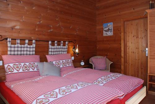 a bedroom with a bed with red and white sheets at Salzano Basic Rooms Interlaken in Interlaken