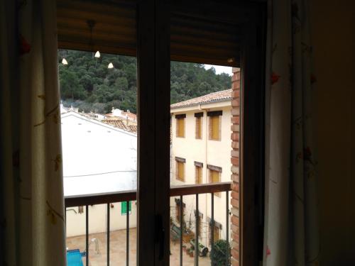 a window with a view of a building at Apartamentos Valle del Guadalquivir in Arroyo Frio