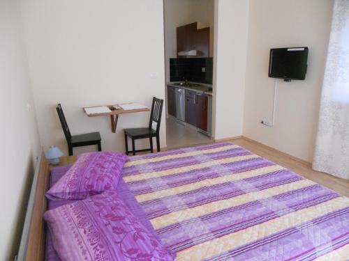a bedroom with a bed and a table and chairs at Apartments Alen in Umag