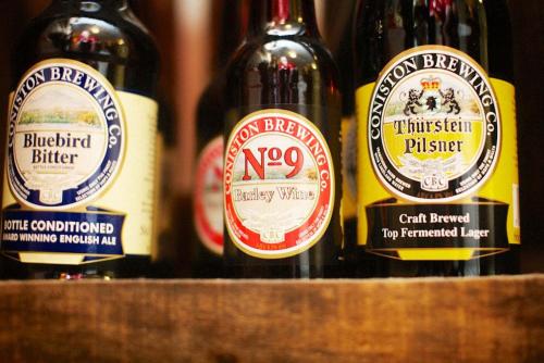 three bottles of wine sitting on a shelf at Bank Ground Farm in Coniston