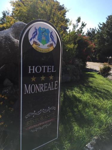 a sign for a hotel morgue in the grass at Hotel Monreale in Sardara