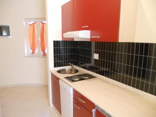 a kitchen with a sink and a counter top at Apartments Alen in Umag