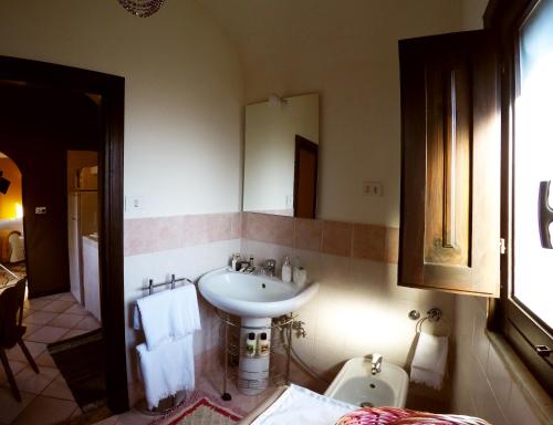 a bathroom with a sink and a toilet at AltoBarocco House in Catania