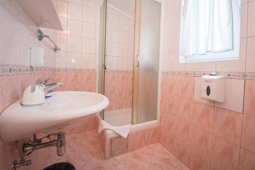 W łazience znajduje się umywalka i prysznic. w obiekcie Bed and Breakfast Helena w mieście Kaštela
