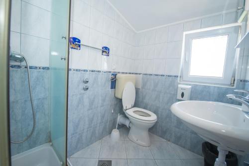 a bathroom with a toilet and a sink at Guesthouse Helena in Kaštela