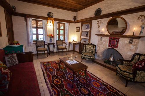 a living room with a fireplace and a table and chairs at Hoyran Wedre Country Houses in Davazlar