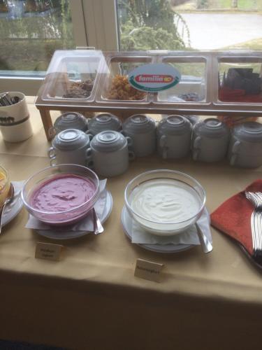 a table with two pans of food on a counter at Hotel Restaurant Heidihof in Maienfeld
