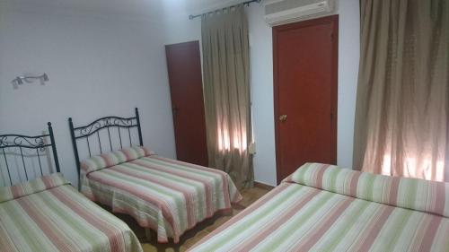 
Cama o camas de una habitación en Hostal Tamarindos
