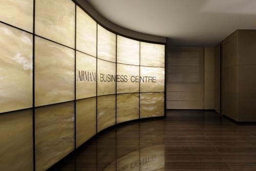 a hallway of a building with the entrance to a learning illness centre at Armani Hotel Milano in Milan