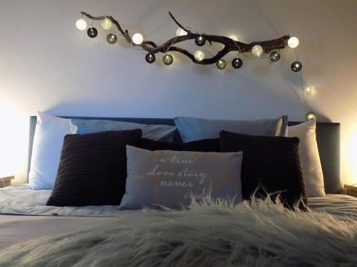 a bed with a headboard with lights on it at (La parenthese) in Hombourg
