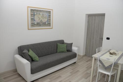 a living room with a couch and a table at Casa di Bacco in Vetralla