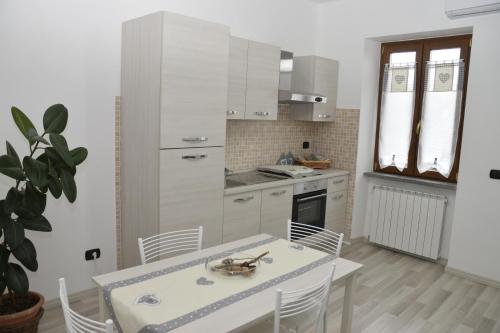 a kitchen with a table and chairs in a room at Casa di Bacco in Vetralla