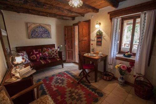 a living room with a couch and a table at Hoyran Wedre Country Houses in Davazlar