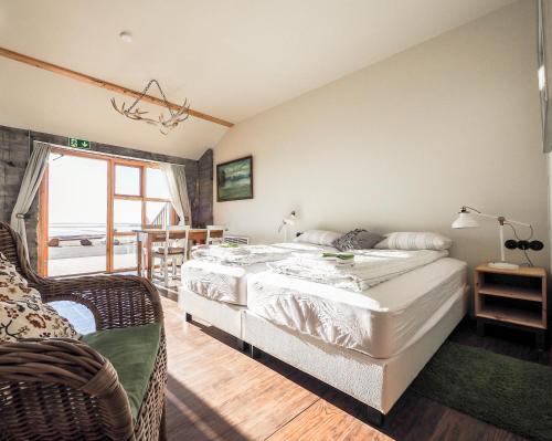 a bedroom with a large bed and a window at The Garage in Varmahlíð