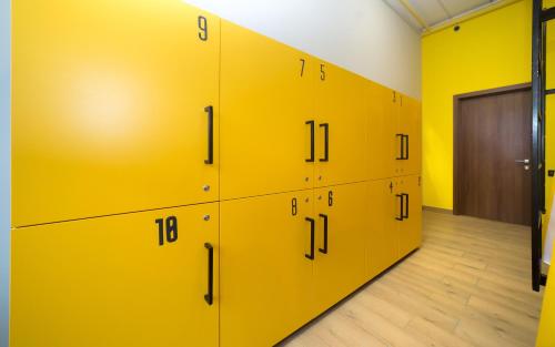 a row of yellow lockers in a room at HOTEL Bee Station in Kyiv