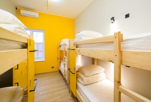 a room with three bunk beds and a window at HOTEL Bee Station in Kyiv