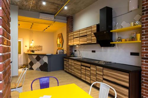 a kitchen with a table and chairs in a room at HOTEL Bee Station in Kyiv