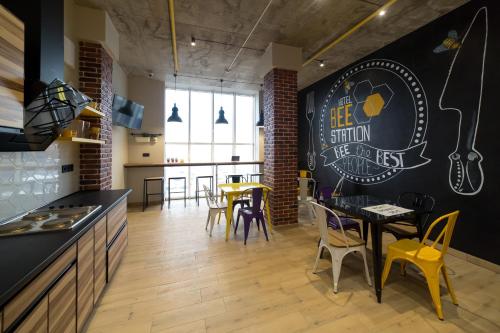 a kitchen and dining room with a table and chairs at HOTEL Bee Station in Kyiv