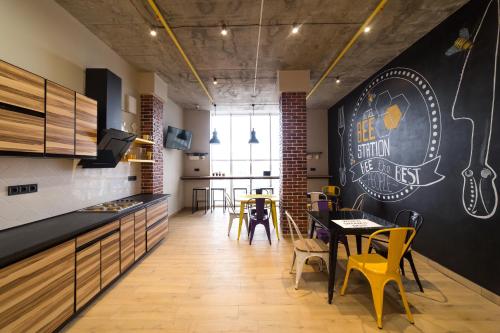 a kitchen and dining room with a chalkboard wall at HOTEL Bee Station in Kyiv
