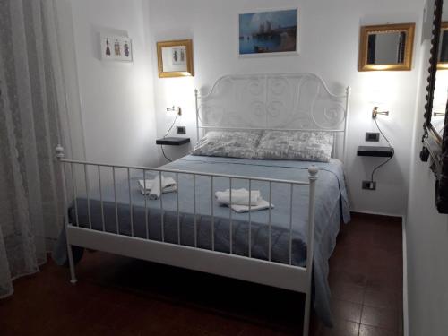 a bedroom with a white bed with two towels on it at La Stanza a parte in Naples