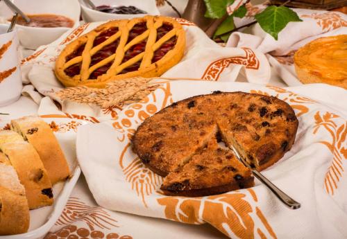 a table topped with bread and a pie on top at Hotel Felix in Rimini