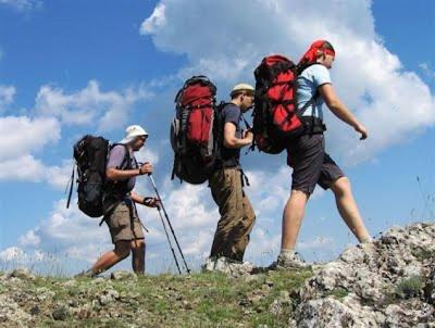 three men walking up a hill with backpacks on at Bassano Up in Mussolente 