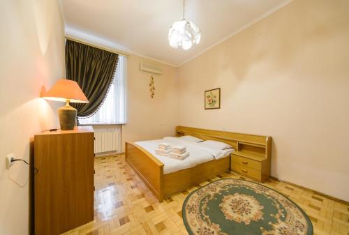 キーウにあるКрасивая 3х комнатная на Майданеのベッドとラグ付きの小さなベッドルーム1室が備わります。