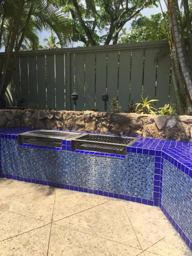a swimming pool with blue tile on a fence at Modern, Romantic Vibes in the Tropics in Kahuku