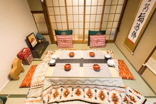 a room with a table with food on it at City Center 200 Years Old Traditional House Next to 2 Train Lines in Kyoto