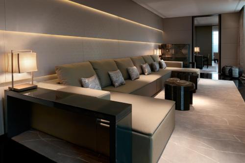 a living room with a couch and a television at Armani Hotel Milano in Milan