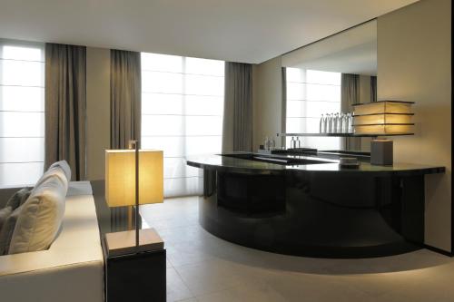 a bathroom with a large black tub in a room at Armani Hotel Milano in Milan