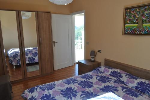 a bedroom with a bed with a blue and white comforter at Holiday home near Monte Baldo in Tremosine Sul Garda in Tremosine Sul Garda