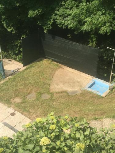 a garden with a blue pool in the grass at Casa Parentela in Ligornetto