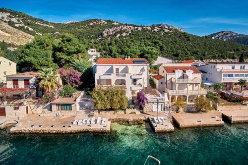an aerial view of a house on the water at Repic Apartments in Klek