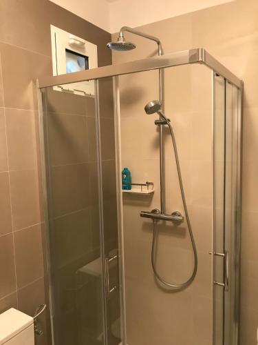 a shower with a glass door in a bathroom at Karla in Vis