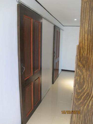 a corridor with two doors and a room at Cabilao Sunset Dive & Beach Resort in Loon