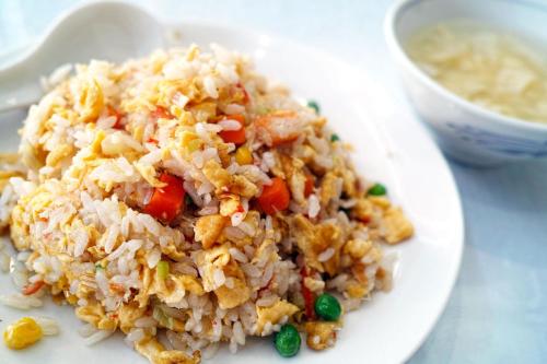 a white plate of rice and a bowl of soup at Hallmark View Hotel in Melaka