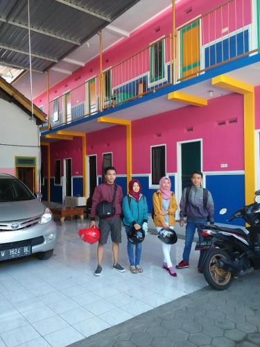 a group of people standing in front of a building at Homestay Lidiya in Banyuwangi