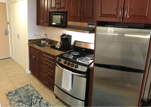 a kitchen with a stainless steel stove and a sink at Amazing Kihei Kai Nani - Maui Vista One Bedroom Condos in Kihei