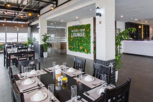 a restaurant with tables and chairs and a sign that reads happy meal turning at Sunrise Hanoi Hotel in Hanoi