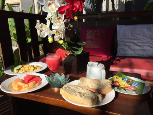 a table with three plates of food on it at Ratna Villa 4 in Ubud