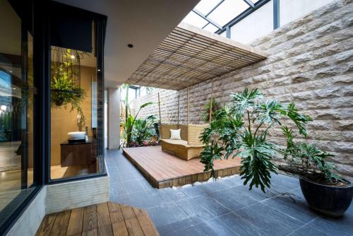 an indoor courtyard with a couch and potted plants at Shu Jia Motel in Taichung