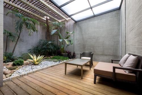 an indoor garden with a couch and a table in a room at Shu Jia Motel in Taichung