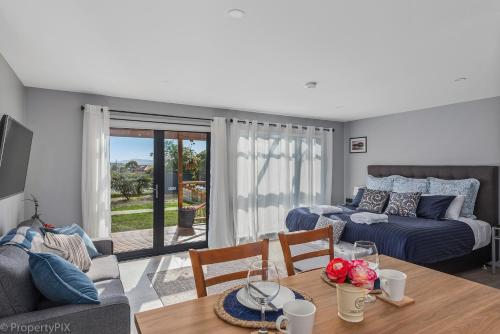 a living room with a couch and a table and a bed at Harrison Grove in Forcett